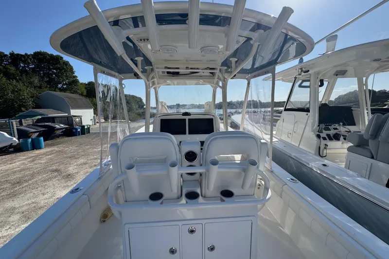 Slide: The Image of 2017 Regulator 28 boat interior with helm station and seating, docked outdoors. - 28