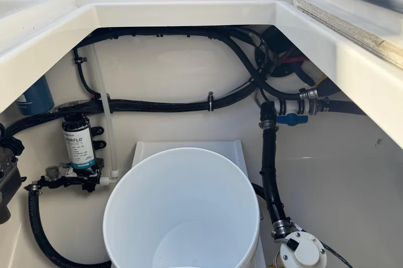 Slide: The Image of 2017 Regulator 28 boat interior showing plumbing and wiring components. - 29