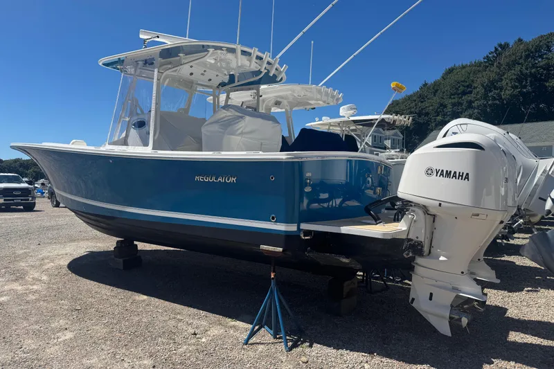Slide: The Image of 2017 Regulator 28 boat with Yamaha engines on display outdoors. - 3