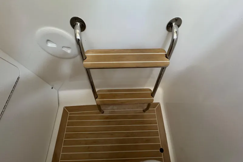 Slide: The Image of Wooden ladder and floor inside 2017 Regulator 28 boat cabin. - 32