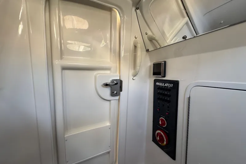 Slide: The Image of Interior of a 2017 Regulator 28 boat, featuring control panel and door. - 33