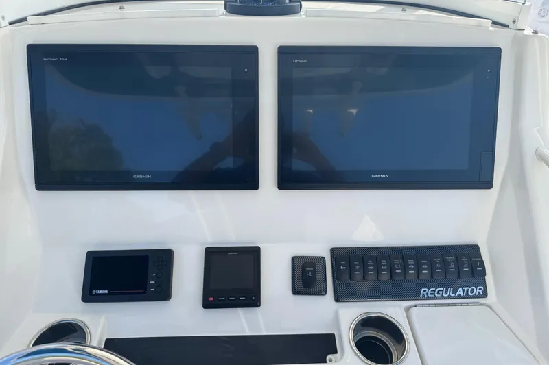 Slide: The Image of 2017 Regulator 28 boat dashboard with dual Garmin displays and control panel. - 39
