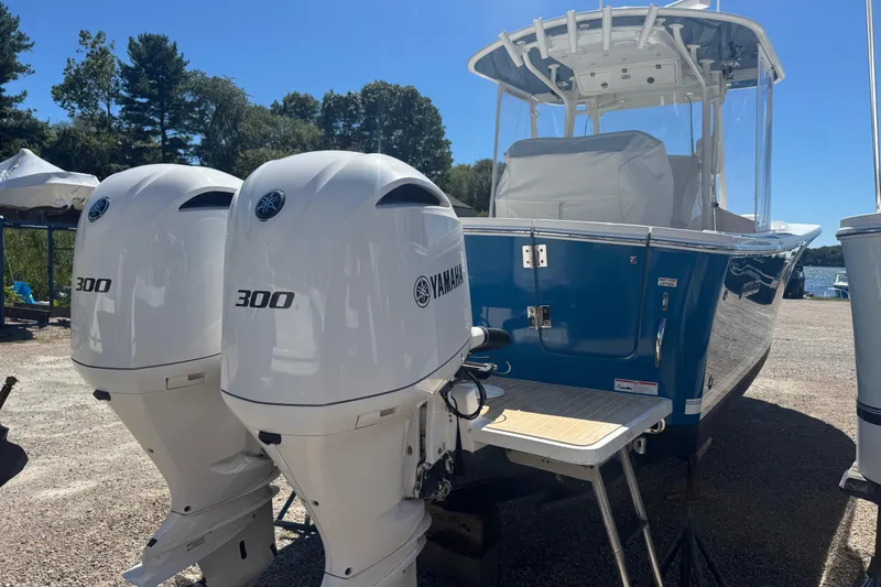 Slide: The Image of 2017 Regulator 28 boat with dual Yamaha 300 engines, docked outdoors. - 4