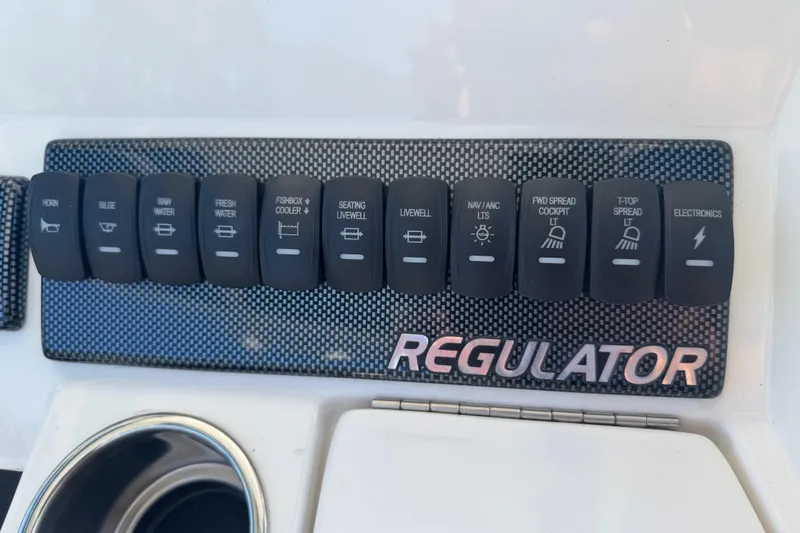 Slide: The Image of Control panel of a 2017 Regulator 28 boat with labeled switches. - 40