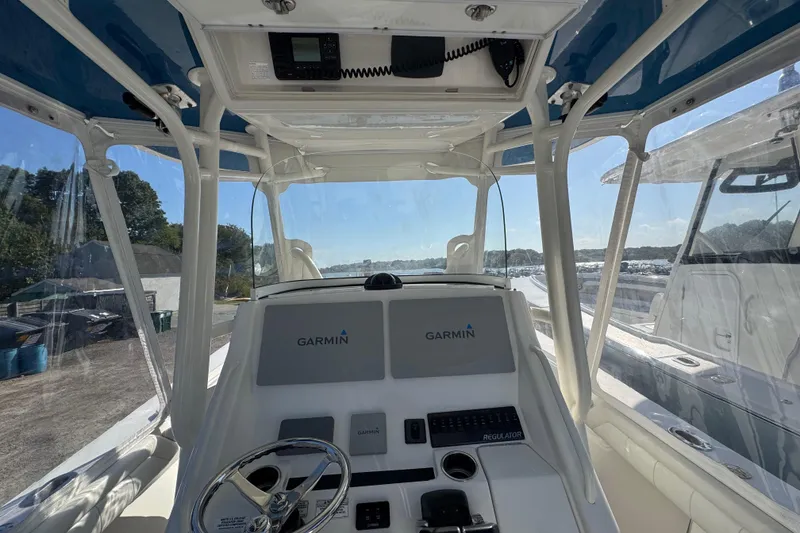Slide: The Image of 2017 Regulator 28 boat cockpit with Garmin navigation system and steering wheel. - 41