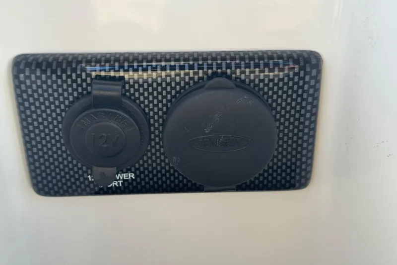 Slide: The Image of 2017 Regulator 28 marine 12V power port with carbon fiber panel. - 44