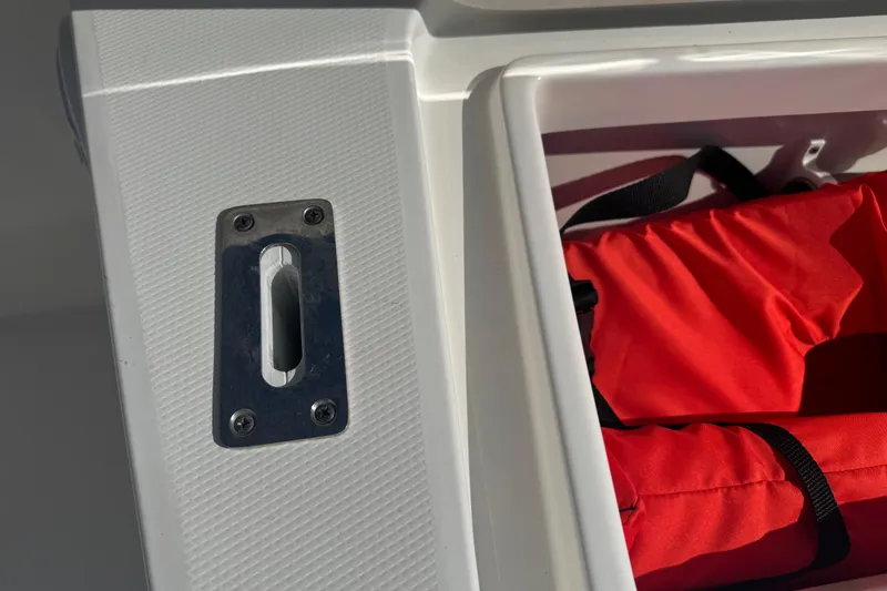 Slide: The Image of 2017 Regulator 28 boat detail with red life jacket in storage compartment. - 50