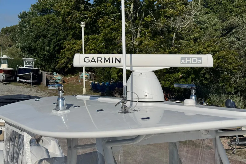 Slide: The Image of 2017 Regulator 28 boat with Garmin xHD2 radar, docked near trees. - 53