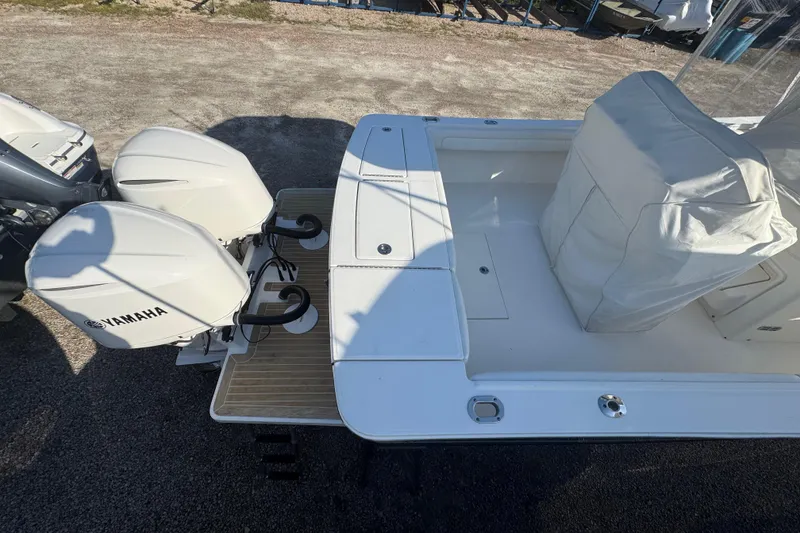 Slide: The Image of 2017 Regulator 28 boat with twin Yamaha outboard engines, covered seating area. - 54