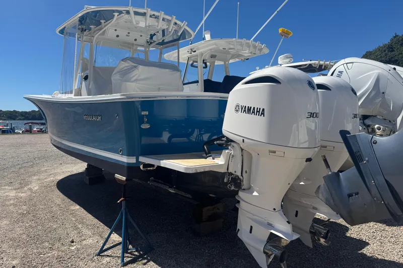 Slide: The Image of 2017 Regulator 28 boat with twin Yamaha 300 engines, displayed outdoors. - 7
