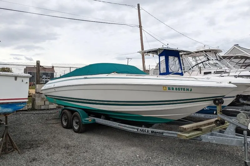 The Image of 1998 Formula 252 SS boat on trailer, covered, parked in a marina. - 0