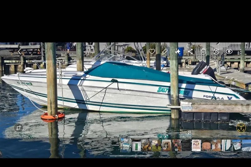 Slide: The Image of 1998 Formula 252 SS boat docked at a marina, featuring a sleek white and teal design. - 11