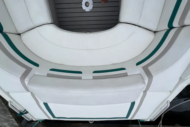 Slide: The Image of 1998 Formula 252 SS boat interior with white and teal seating. - 13