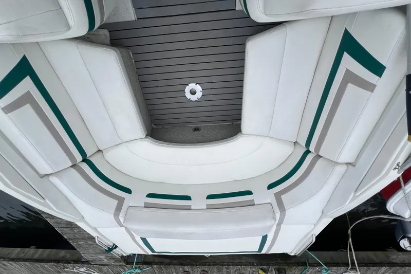 Slide: The Image of 1998 Formula 252 SS boat interior with white and green seating, docked by the water. - 14