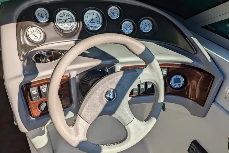 Slide: The Image of 1998 Formula 252 SS boat dashboard with gauges and steering wheel. - 17