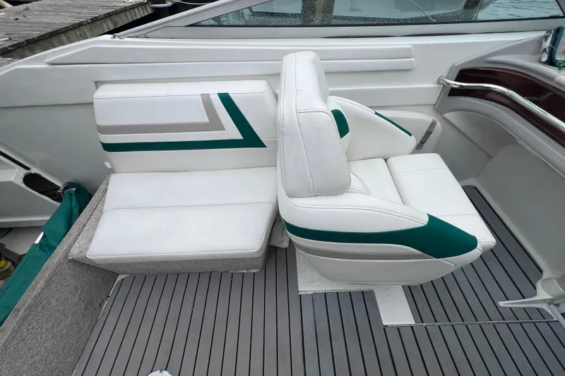 Slide: The Image of 1998 Formula 252 SS boat interior with white and green seating on gray deck. - 18
