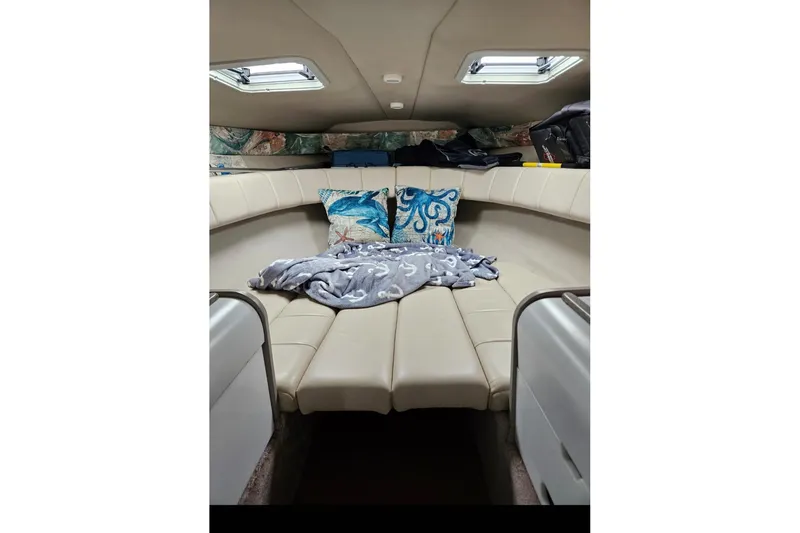 Slide: The Image of 1998 Formula 252 SS boat interior with beige seating, pillows, and skylights. - 2