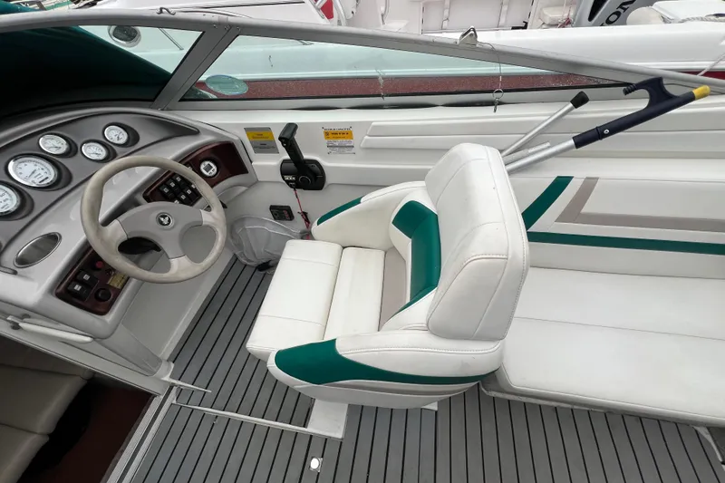 Slide: The Image of 1998 Formula 252 SS boat cockpit with steering wheel, gauges, and white seating. - 20