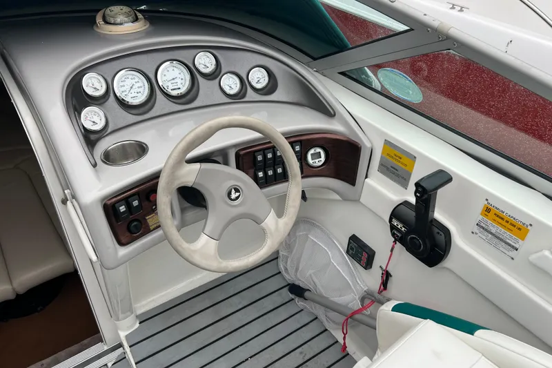 Slide: The Image of 1998 Formula 252 SS boat dashboard with steering wheel and gauges. - 22