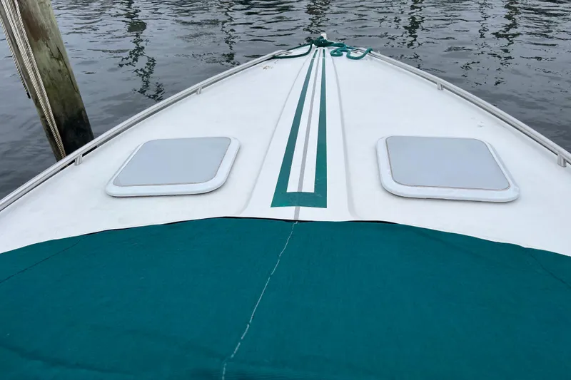 Slide: The Image of Bow of 1998 Formula 252 SS boat with green cover and water reflection. - 23