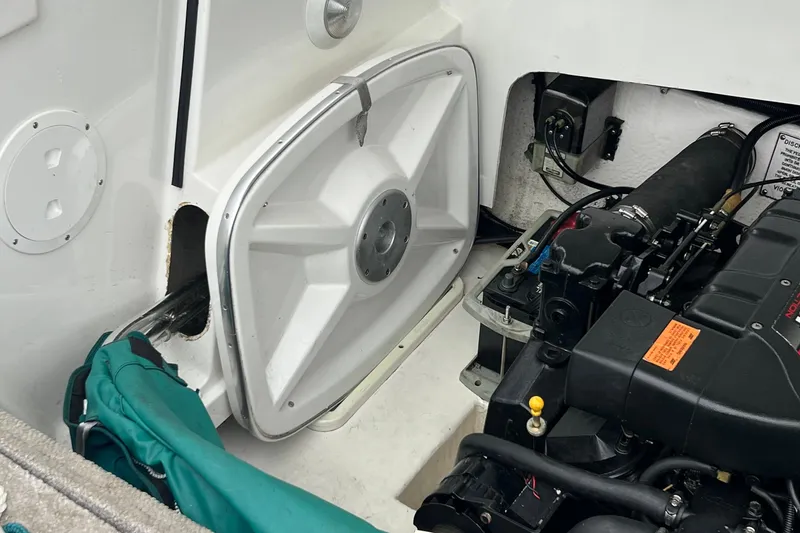 Slide: The Image of Engine compartment of a 1998 Formula 252 SS boat, showing mechanical components and storage area. - 29