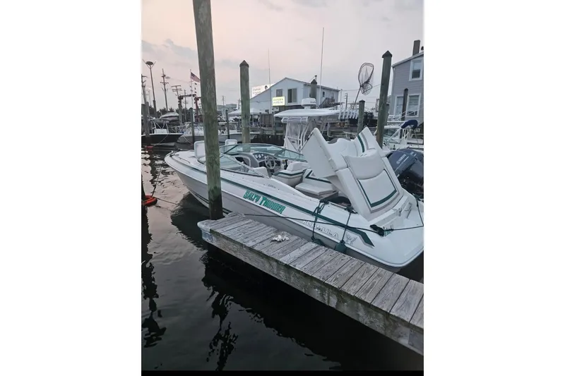 Slide: The Image of 1998 Formula 252 SS boat docked at marina during sunset. - 3