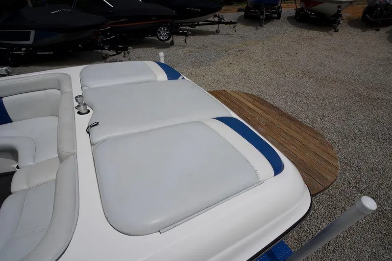 Slide: The Image of 2003 Tigé 22V Riders Edition boat with white seating and wooden swim platform. - 11