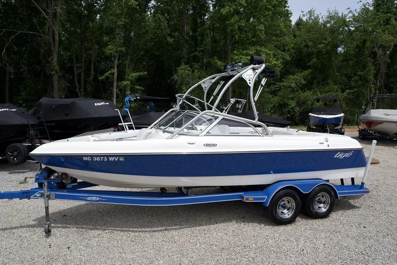 Slide: The Image of 2003 Tigé 22V Riders Edition boat on trailer, parked outdoors. - 3