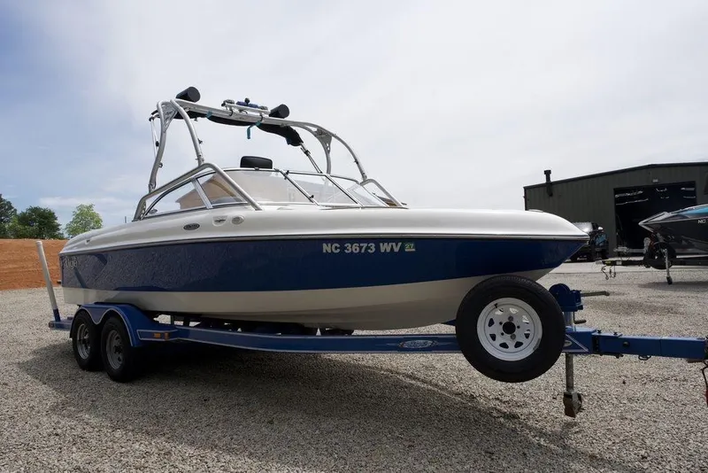 Slide: The Image of 2003 Tigé 22V Riders Edition boat on trailer, parked outdoors. - 4