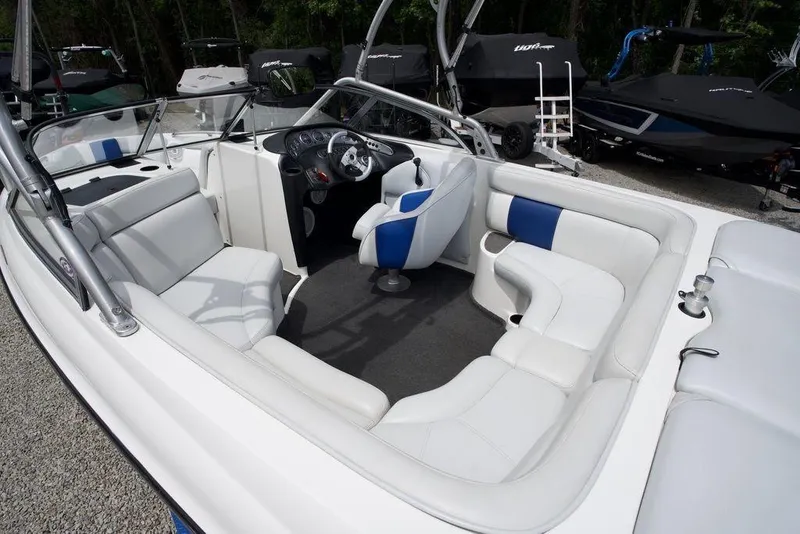 Slide: The Image of 2003 Tigé 22V Riders Edition boat interior with white and blue seating, steering wheel, and dashboard. - 9