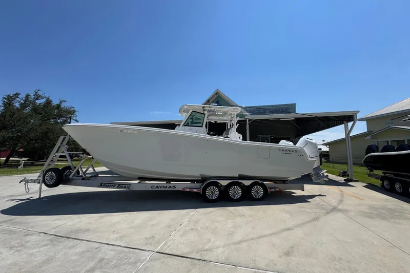 The Image of 2025 Caymas 34 CT boat on trailer under clear blue sky. - 1