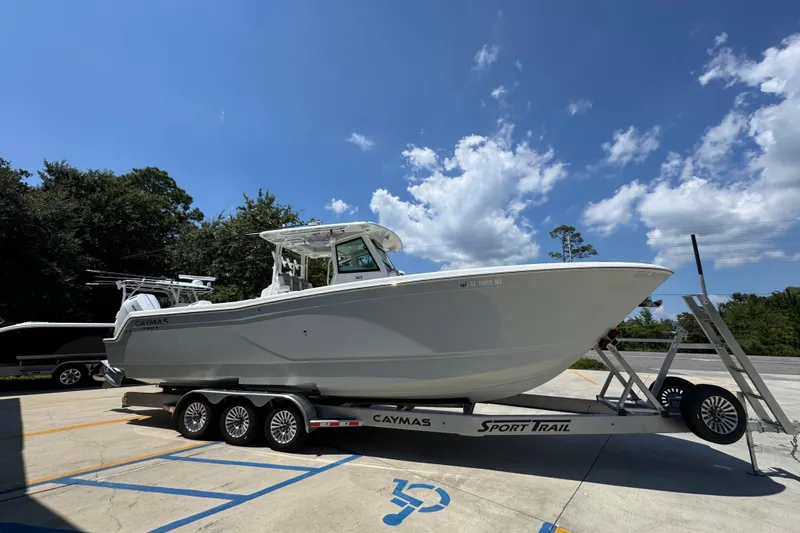 Slide: The Image of 2025 Caymas 34 CT boat on trailer under clear blue sky. - 10