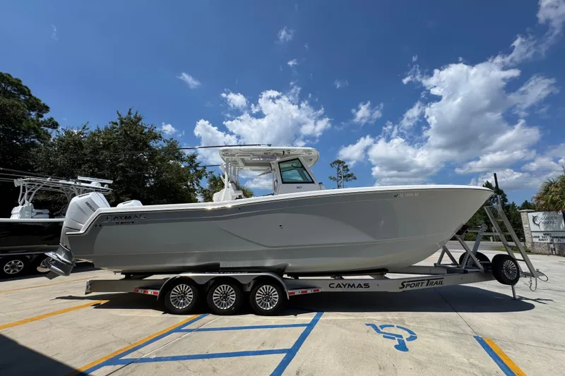 Slide: The Image of 2025 Caymas 34 CT boat on trailer under blue sky. - 11