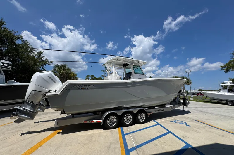 Slide: The Image of 2025 Caymas 34 CT boat on trailer under clear blue sky. - 12