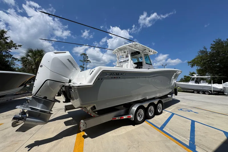 Slide: The Image of 2025 Caymas 34 CT boat on trailer under clear blue sky. - 13