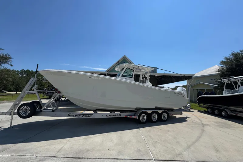 Slide: The Image of 2025 Caymas 34 CT boat on trailer under clear blue sky. - 2