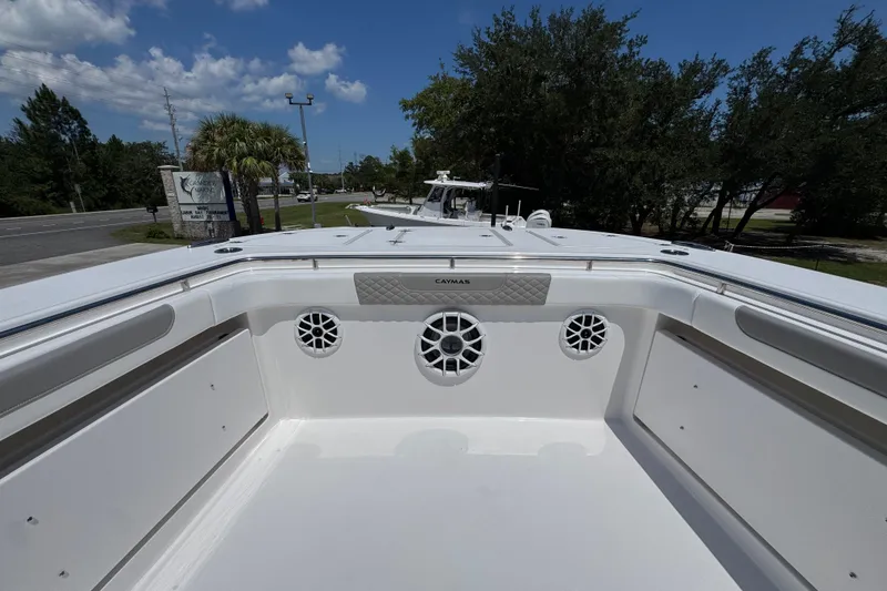 Slide: The Image of 2025 Caymas 34 CT boat deck with speakers, under a clear blue sky. - 20