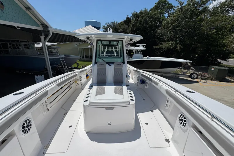 Slide: The Image of 2025 Caymas 34 CT boat, spacious deck, modern design, docked outdoors. - 24