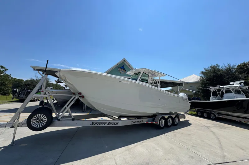 Slide: The Image of 2025 Caymas 34 CT boat on trailer under clear blue sky. - 3