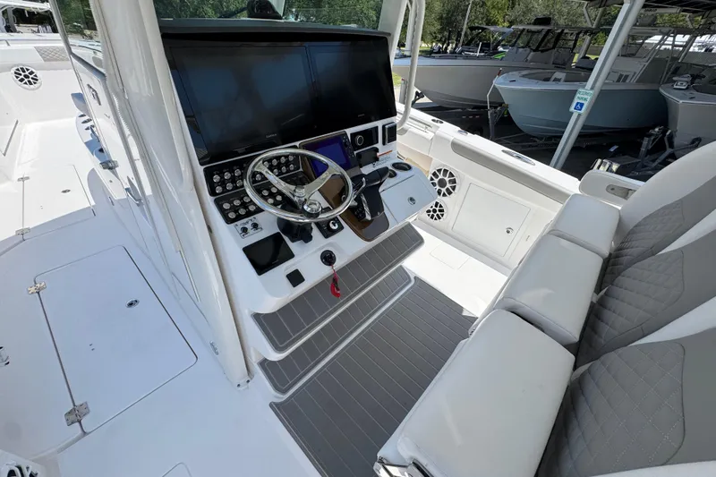 Slide: The Image of 2025 Caymas 34 CT boat interior with modern helm, steering wheel, and seating. - 32