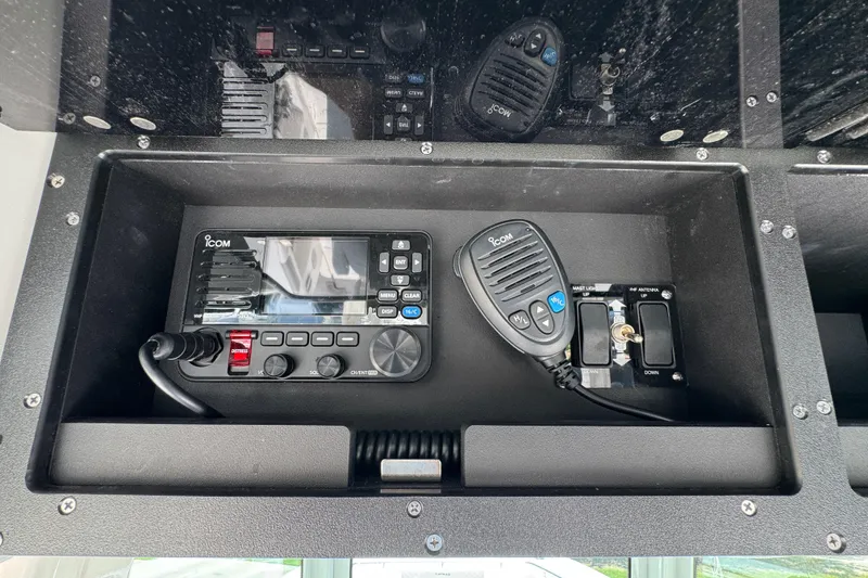 Slide: The Image of ICOM radio system in 2025 Caymas 34 CT boat dashboard compartment. - 36