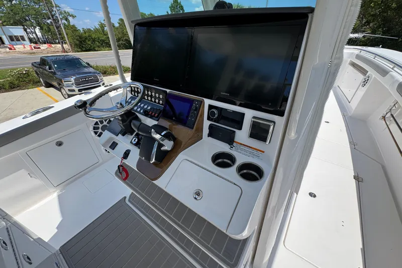 Slide: The Image of 2025 Caymas 34 CT boat helm with advanced navigation screens and controls. - 37