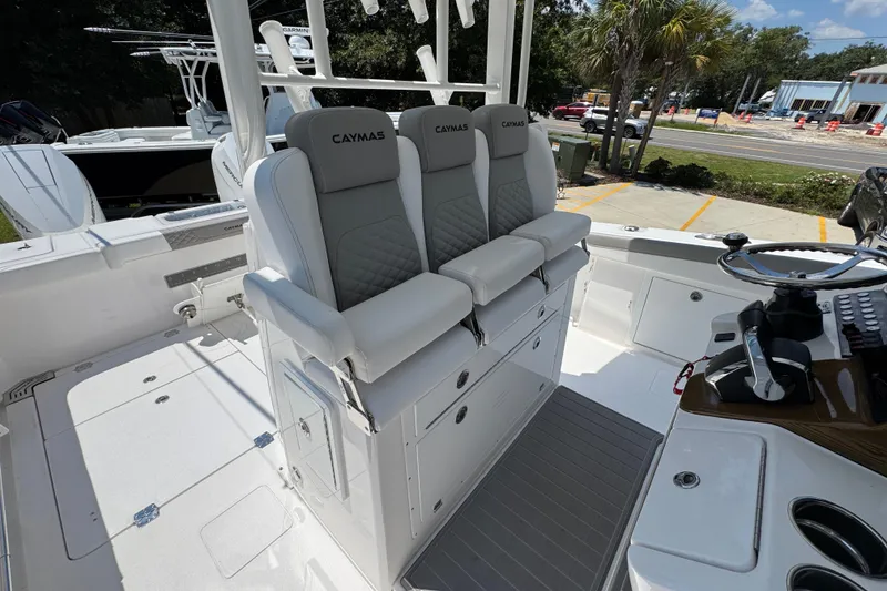 Slide: The Image of 2025 Caymas 34 CT boat interior with cushioned seating and steering console. - 38