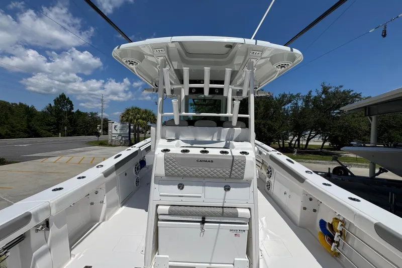Slide: The Image of 2025 Caymas 34 CT boat with sleek design, spacious deck, and modern features under a clear blue sky. - 42