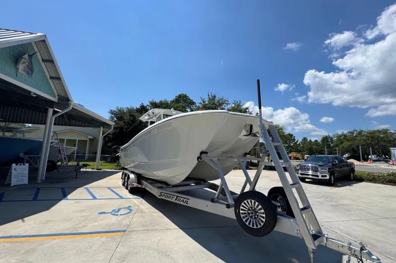 Slide: The Image of 2025 Caymas 34 CT boat on trailer under clear blue sky. - 8
