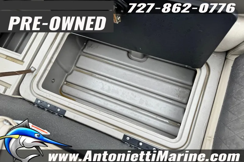 Slide: The Image of Pre-owned 2022 Sun Tracker 22 Sport Fish DLX storage compartment, Antonietti Marine contact details. - 11
