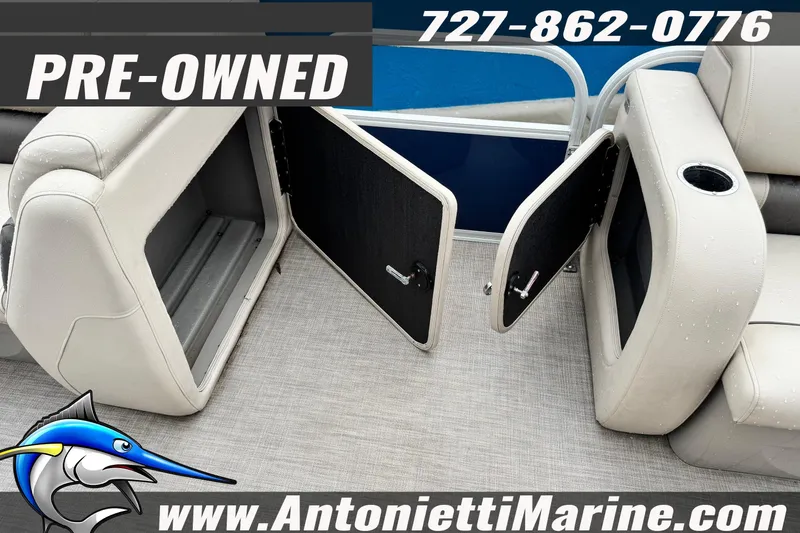 Slide: The Image of Pre-owned 2022 Sun Tracker 22 Sport Fish DLX boat with open storage compartments. - 14