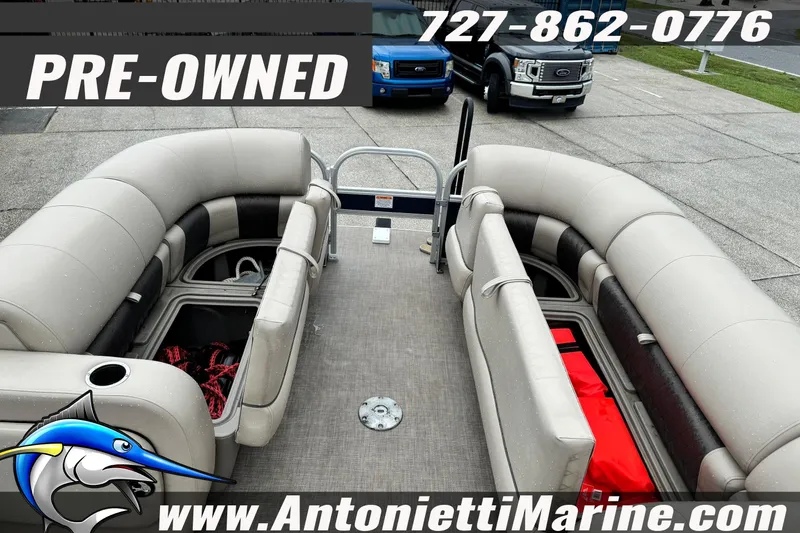Slide: The Image of Pre-owned 2022 Sun Tracker 22 Sport Fish DLX pontoon boat with spacious seating and storage. - 18