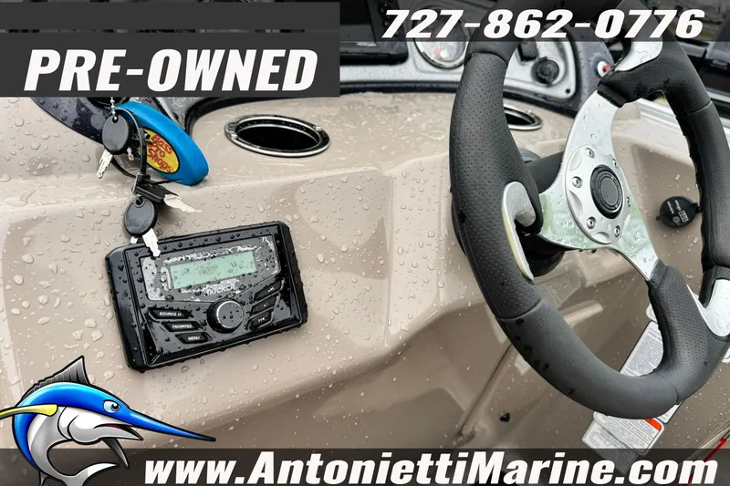 Slide: The Image of Pre-owned 2022 Sun Tracker 22 Sport Fish DLX boat dashboard with steering wheel and controls. - 21