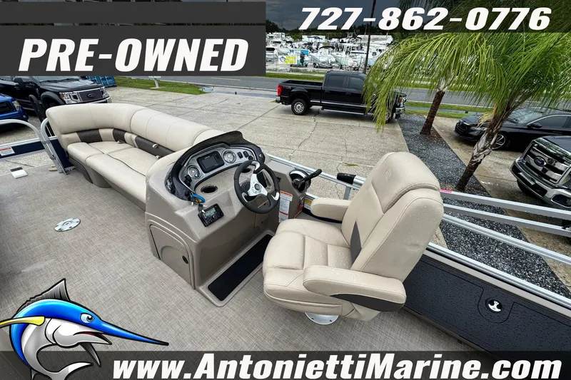 Slide: The Image of Pre-owned 2022 Sun Tracker 22 Sport Fish DLX pontoon boat with seating and steering console. - 24